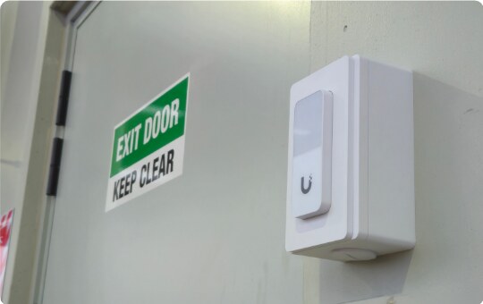 Access control reader beside an exit door at the Medifab facility