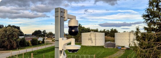 PTZ security camera on a pole at an industrial site