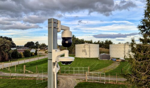 PTZ security camera on a pole at an industrial site